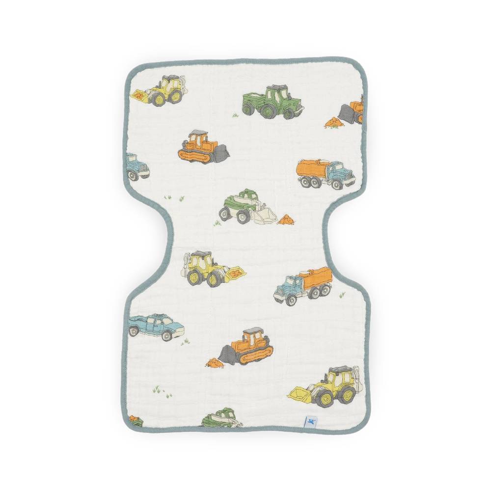A baby muslin burp cloth with a construction vehicle pattern, featuring yellow, green, orange, and blue trucks, bulldozers, and dump trucks on an off-white background with a gray-green border.