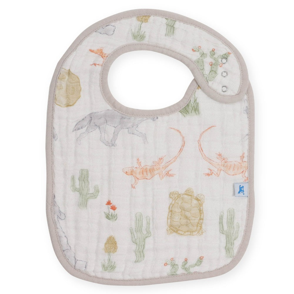Baby bib with desert-themed design featuring lizards and cacti on a white background