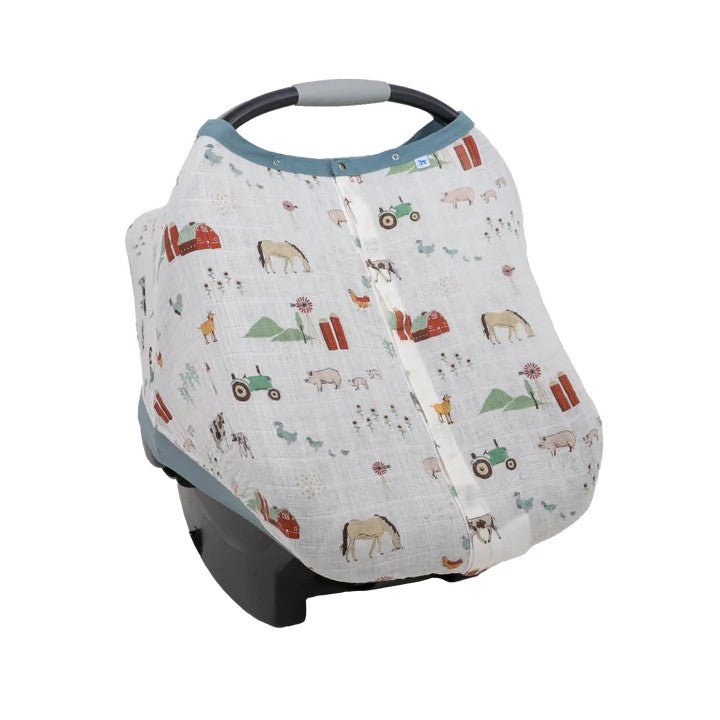 Cotton muslin white farmyard themed baby car seat cover on a white background