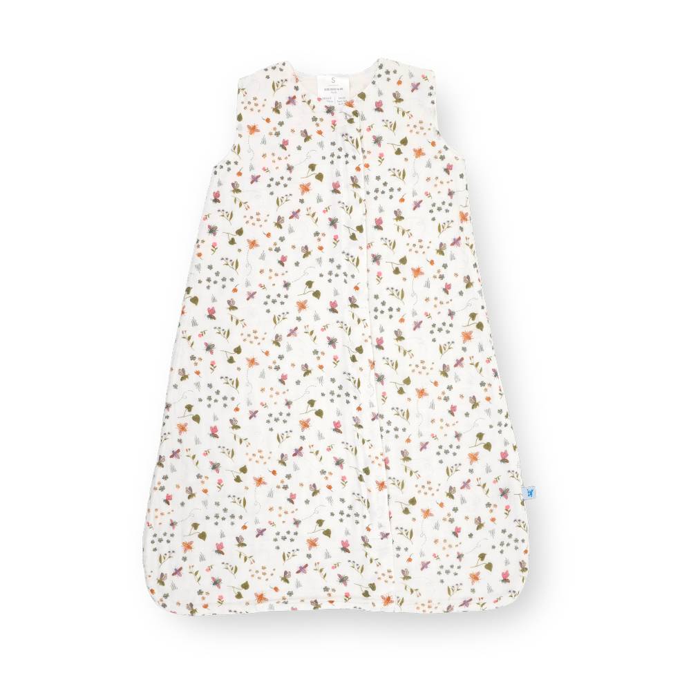 A sleeveless baby sleep sack with an all-over delicate floral and botanical print on a white background, shown flat against a white studio background.