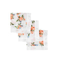 Three set of white floral patterned cloths with white satin trim on a white background