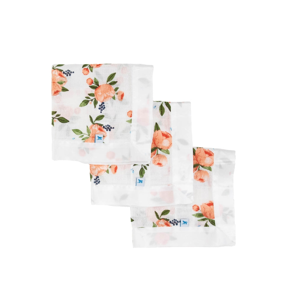 Three set of white floral patterned cloths with white satin trim on a white background