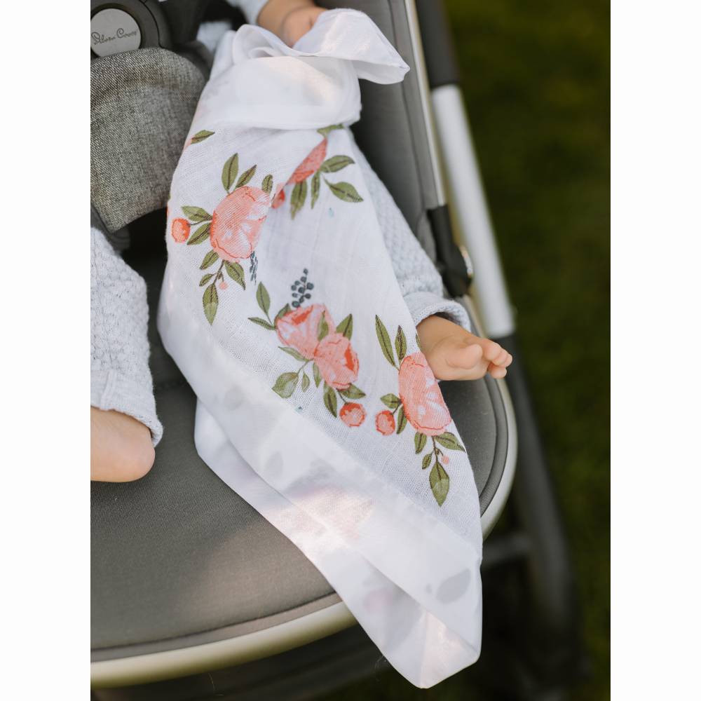 Little Unicorn Floral-patterned security blanket draped over a baby in a stroller