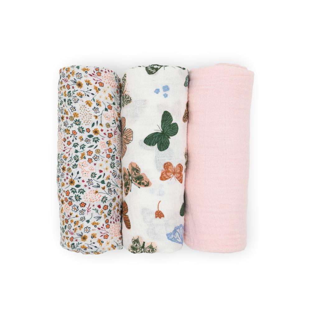 Three little unicorn muslin swaddle blankets with floral, butterfly, and light pink designs on a white background
