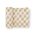 A white and beige checkered cotton muslin swaddle blanket on a white background