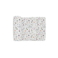 A white cotton muslin swaddle blanket with garden, butterfly theme on a white background