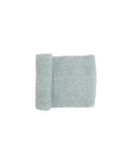 Light green and white patterned cotton muslin fabric on a white background