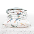 White Stack including baby blanket and pillow with colourful mermaid patterns and dotted sheet on a white background