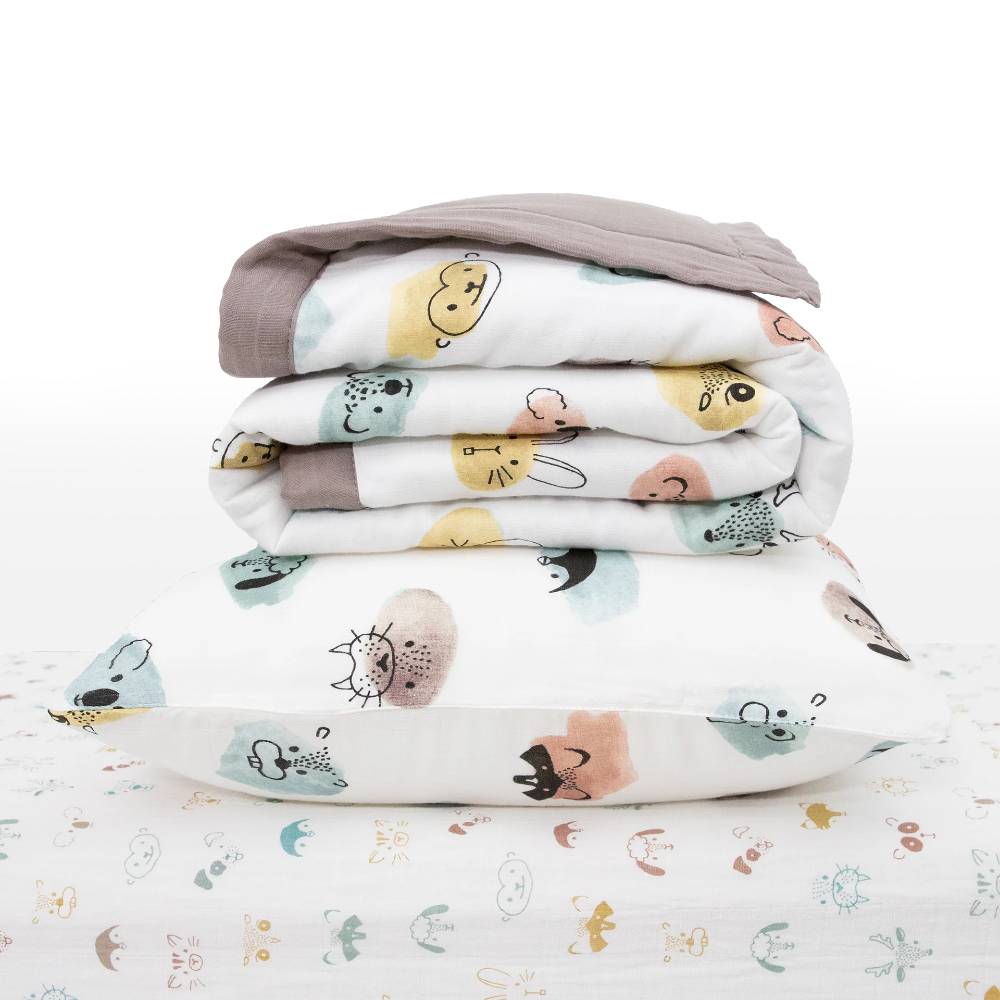 White Stack of baby blanket and pillow with colourful animal patterns on a white background