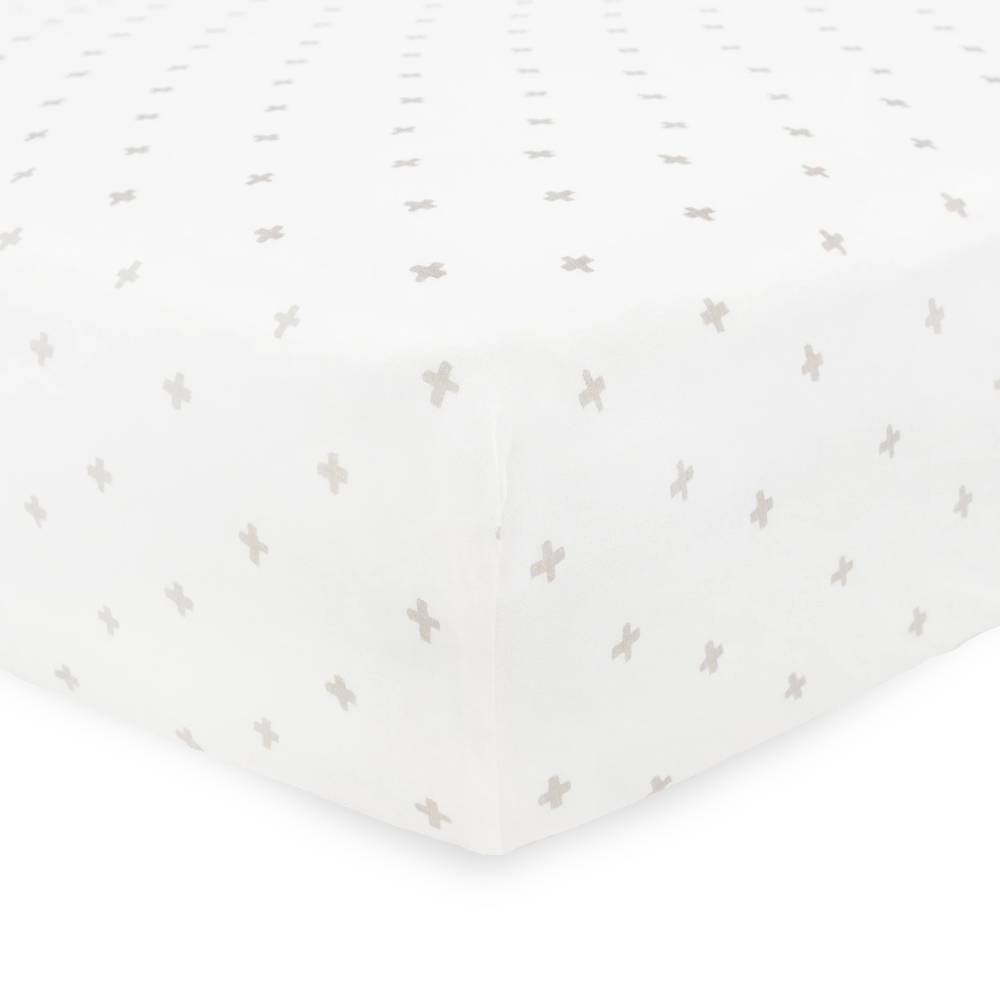 White cot sheet with small gray cross pattern on a mattress with a white background
