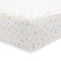 White fitted cot sheet with rainbow and cloud pattern on a white background