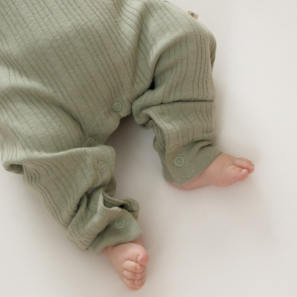 Green baby outfit on a white background