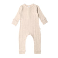 Beige woolbabe baby onesie on a white background