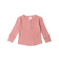 Pink ribbed long-sleeve rib merino top on a white background