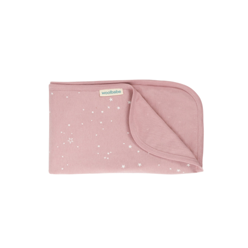Pink woolbabe swaddling baby blanket with star pattern on a white background