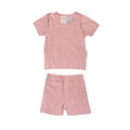 Pink children's woolbabe pajama set with star pattern on a white background