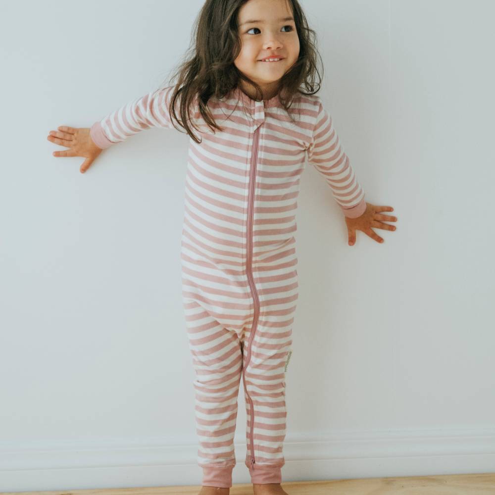 Child wearing a pink and white striped onesie against a plain background