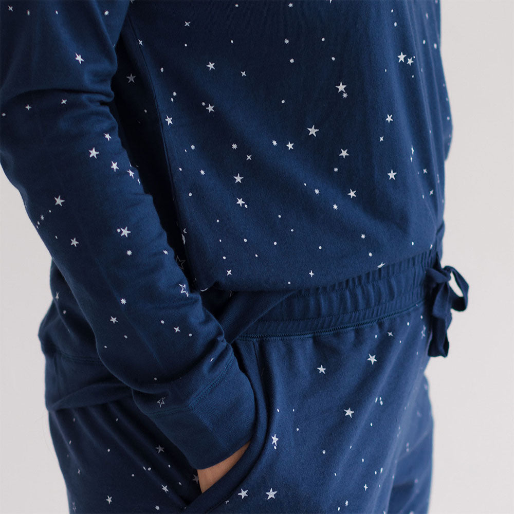 Navy blue pajama set with star pattern on a light gray background