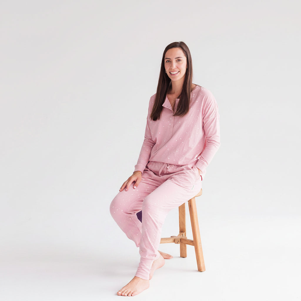 Lady wearing pink pajama set on a white background