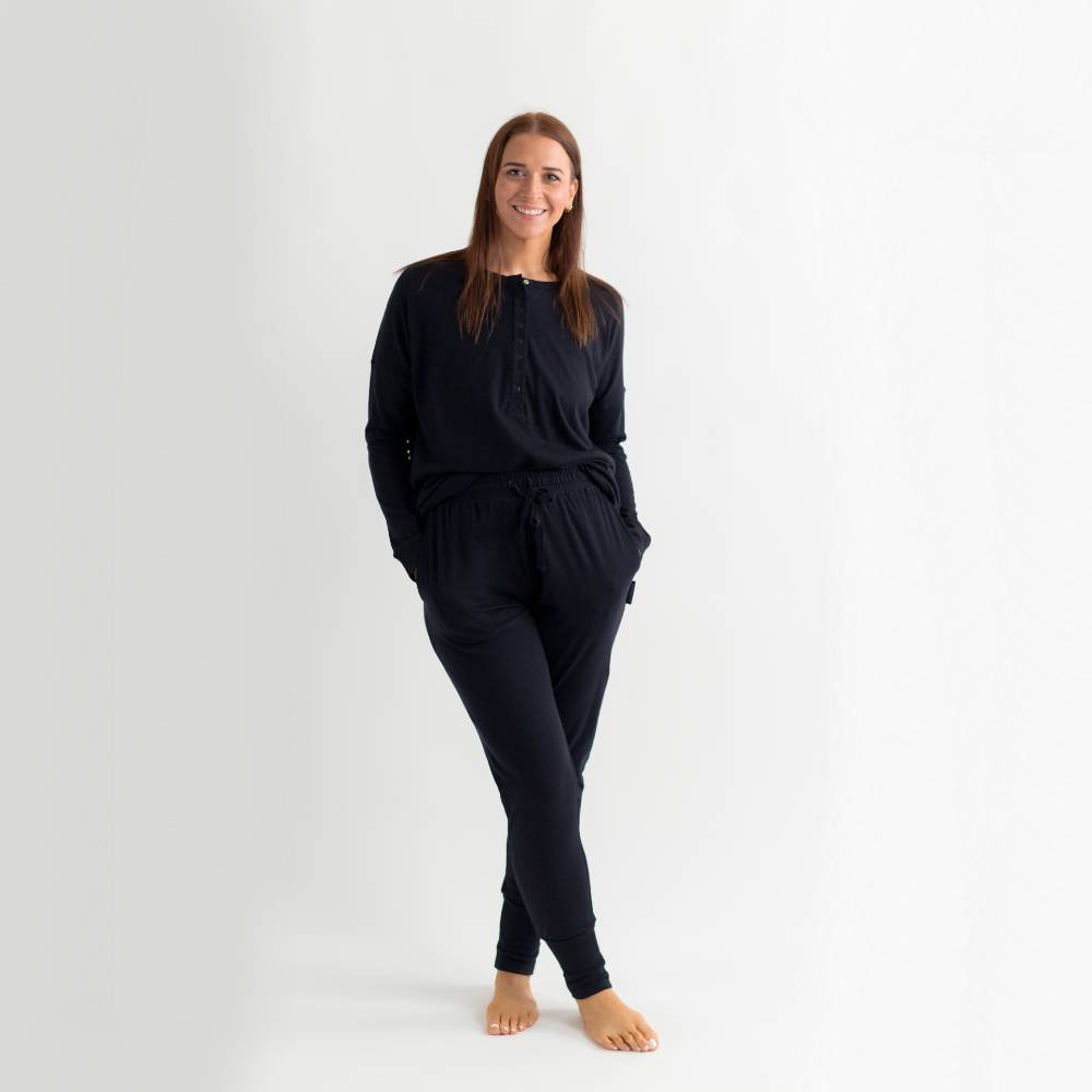 Woman wearing a lounge top and loung epants  on a white background