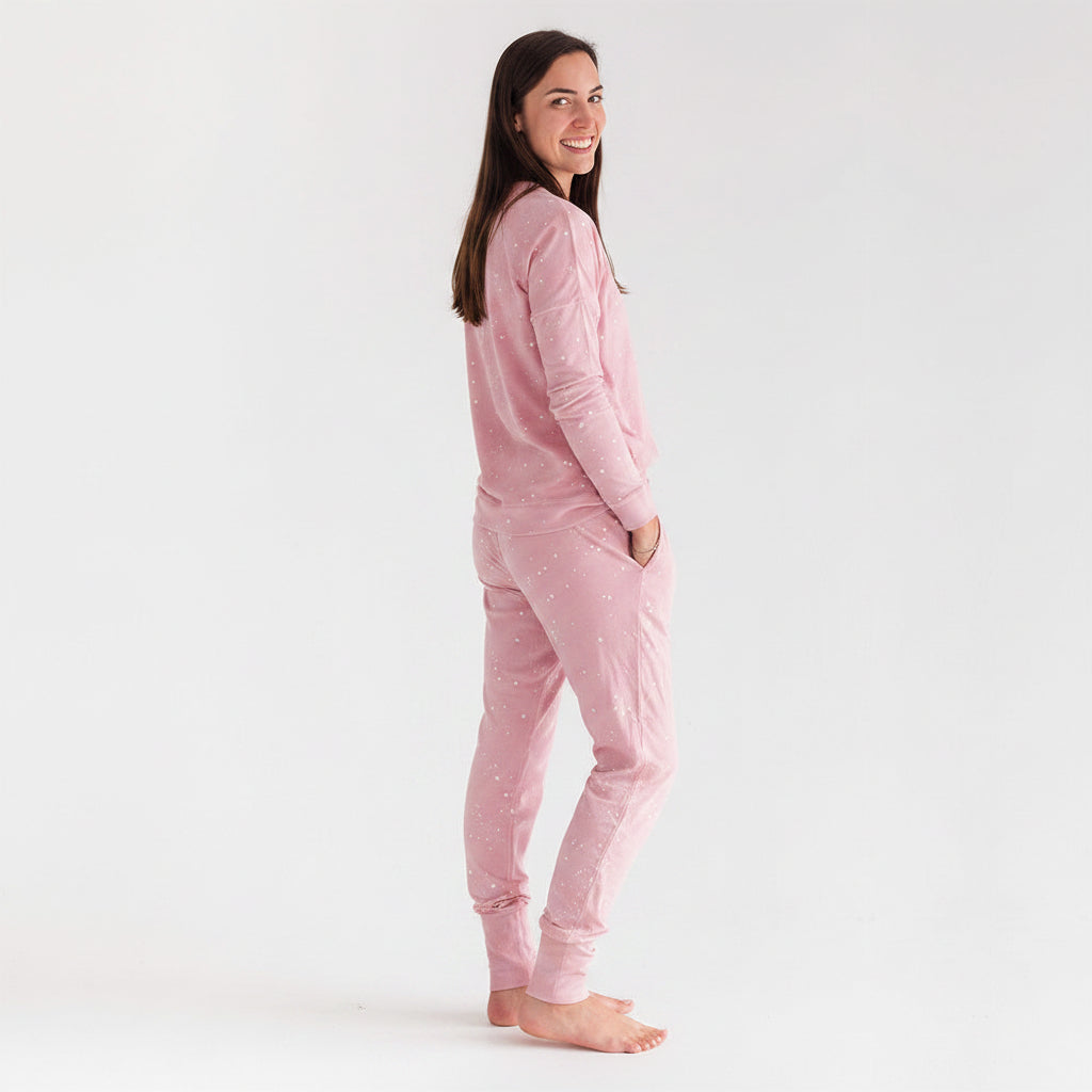 Woman wearing pink pajama sets on a white background