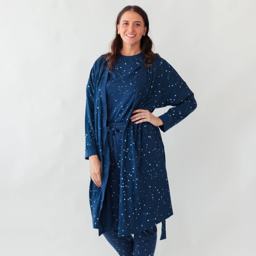 Woman wearing a blue robe with star pattern against a white background