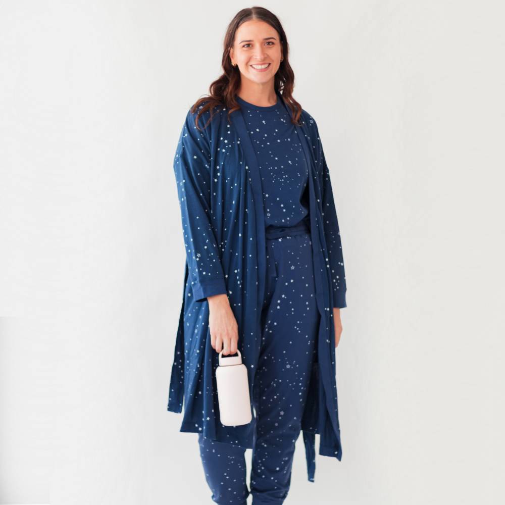 Woman wearing a blue star-patterned outfit against a white background
