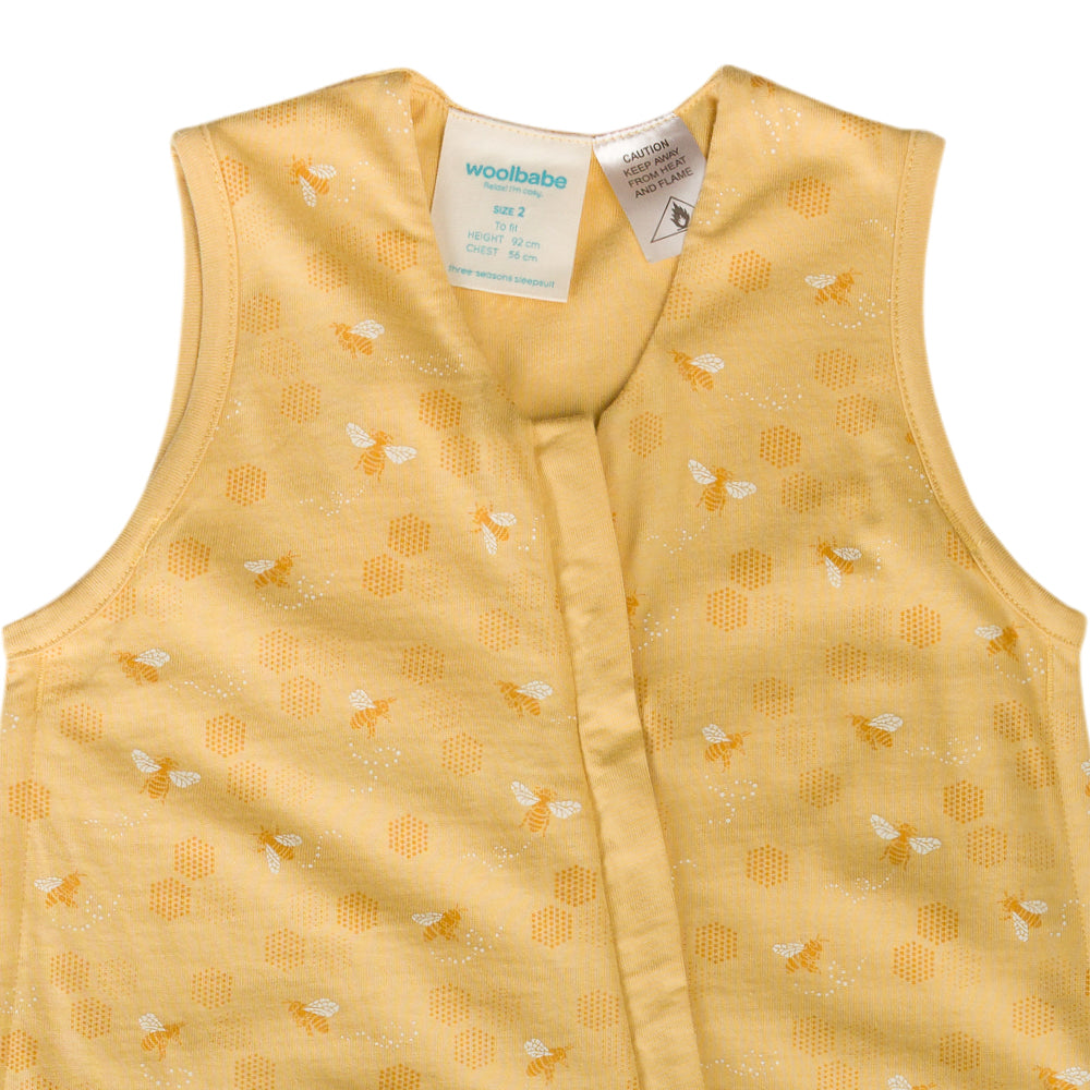 Yellow children's vest with bee pattern and Woolbabe label on a white background