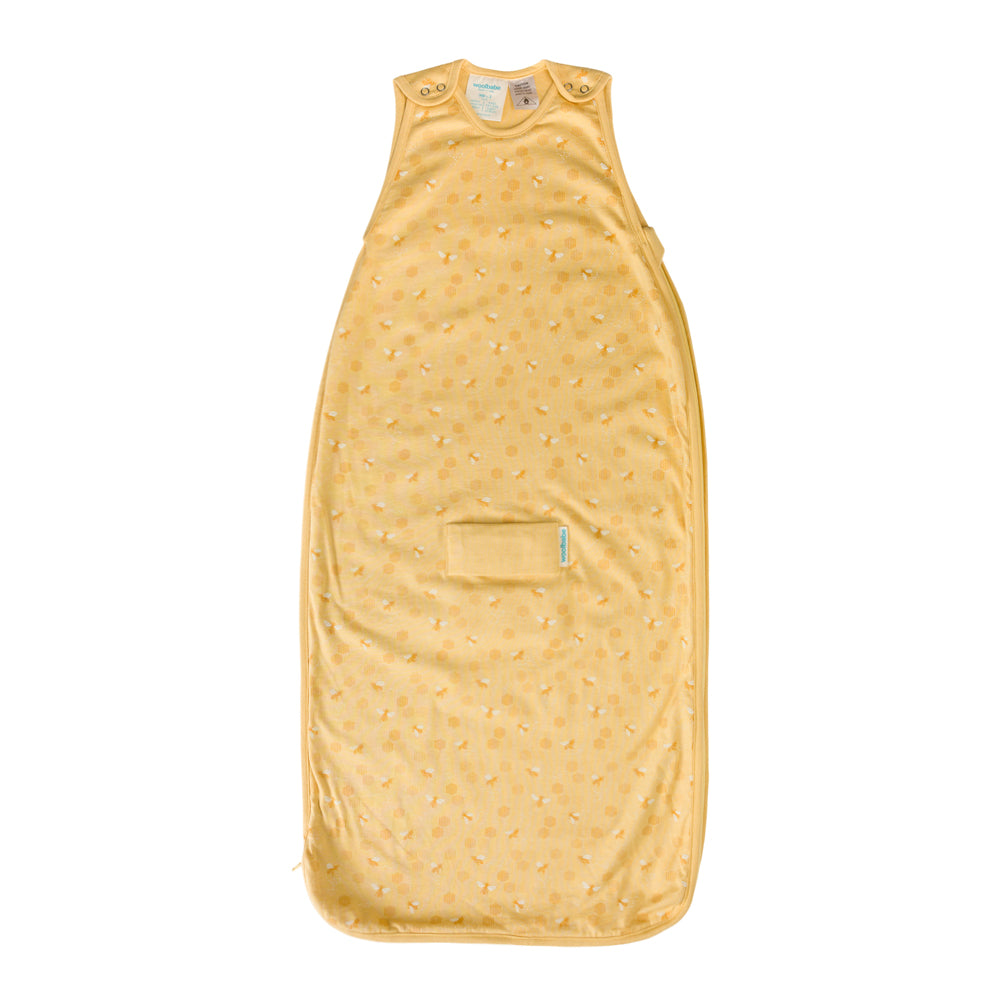 Yellow baby sleeping bag with a subtle bee pattern on a white background