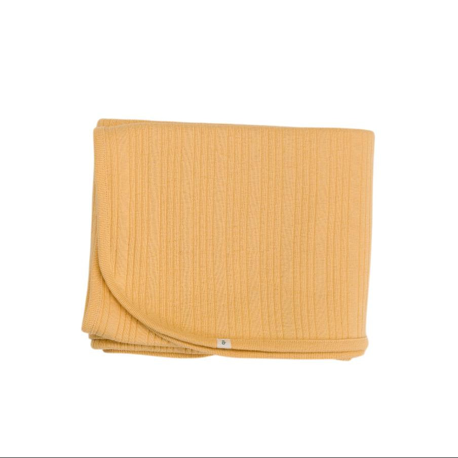 Yellow woolbabe rib swaddle on a white background
