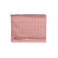 Pink textured woolbabe swaddle blanket on a white background