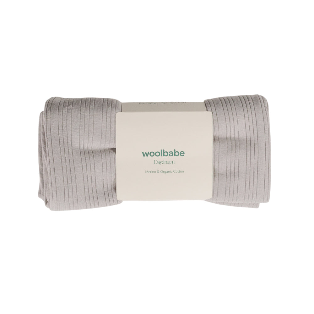 Wool blanket with 'woolbabe' label on a white background