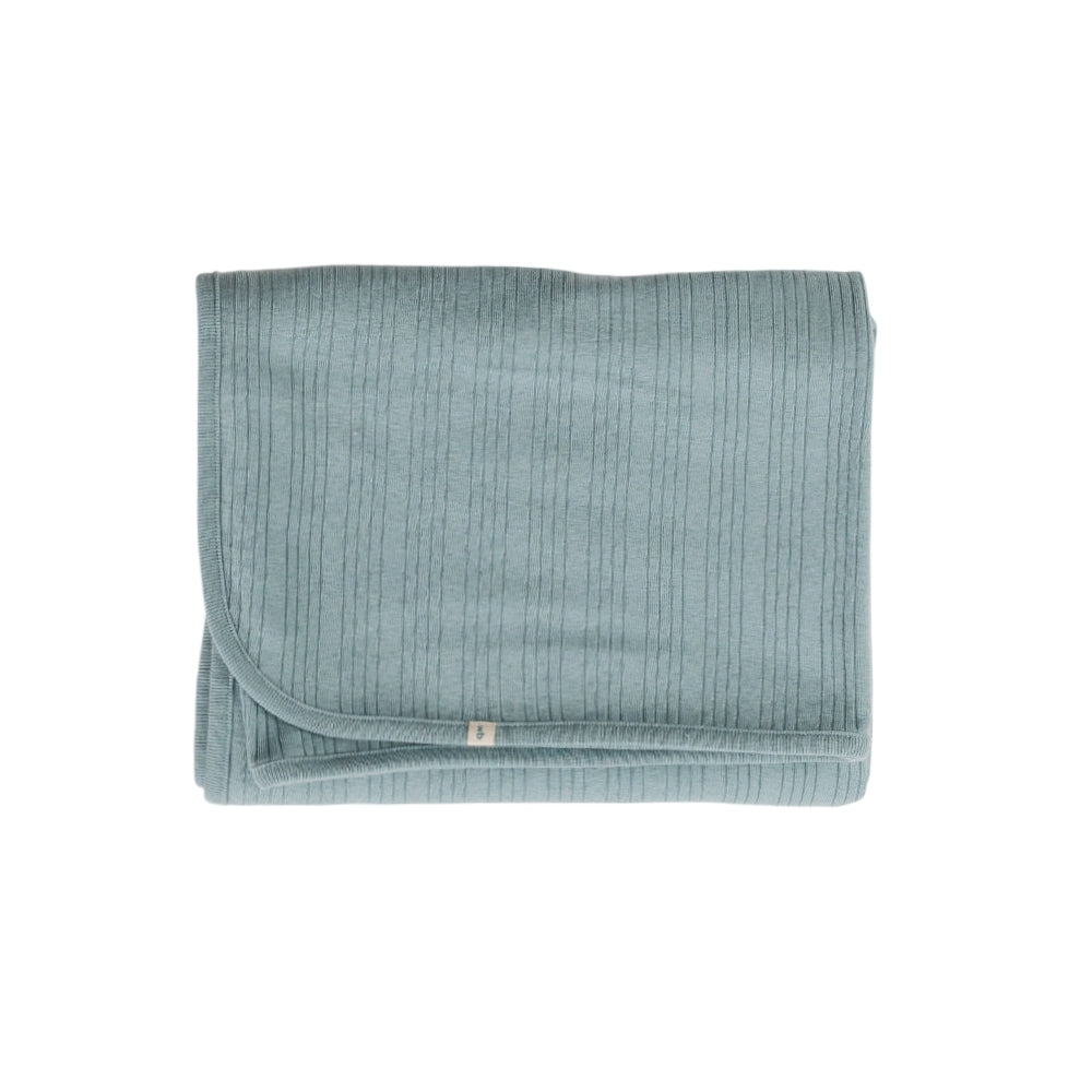 Folded teal baby blanket on a white background