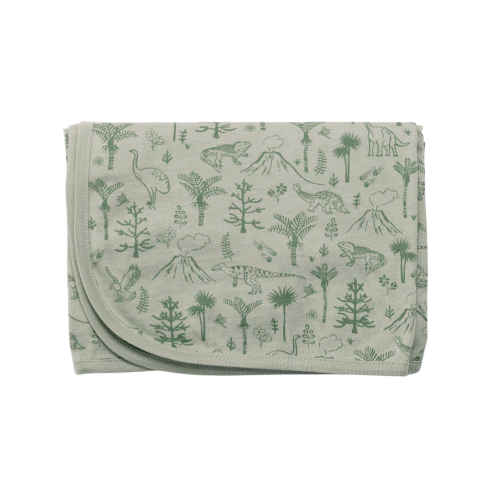 Folded swaddle blanket with green dinosaur and plant pattern on a light gray background