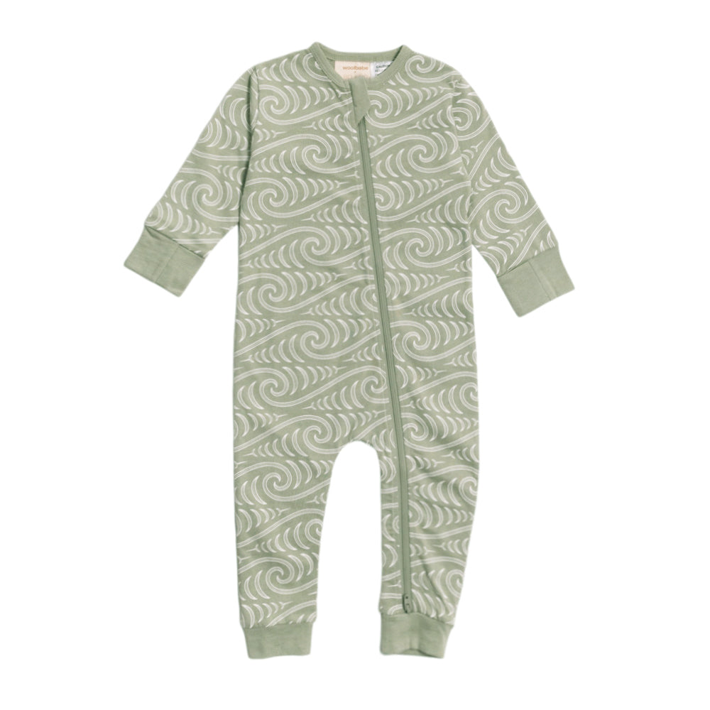 Baby onesie with Maori wave pattern on a white background