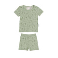 Children's green pajama set with dinosaur nature-themed design on a white background