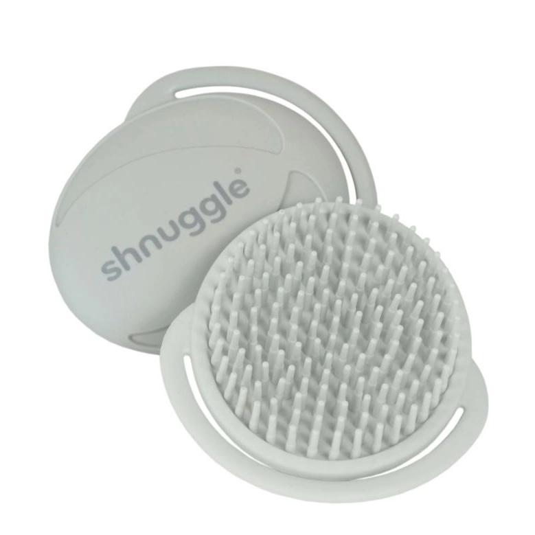 A grey silicone scalp massager brush with a matching lid, shown open on a solid white background. The brand name 'shnuggle' is embossed on the lid.