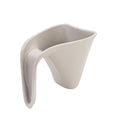 A modern beige plastic jug with a curved handle and angled opening, shown on a plain white background.