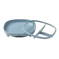 Blue plastic plate and separate divider piece on a white background