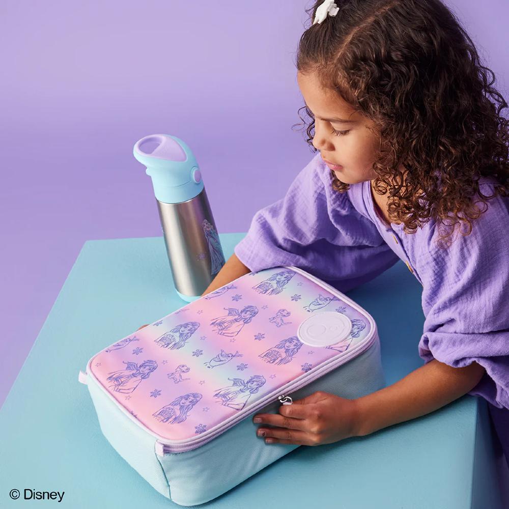 Child with a pink and white insulated lunch bag featuring Disney Frozen characters on a light blue surface with a purple background.