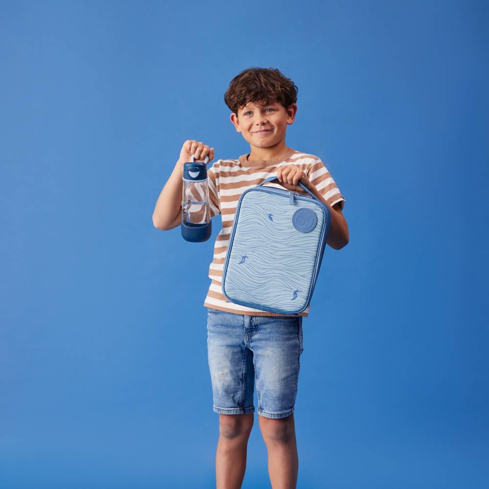 Child holding a blue insulated lunch bag and water bottle against a blue background