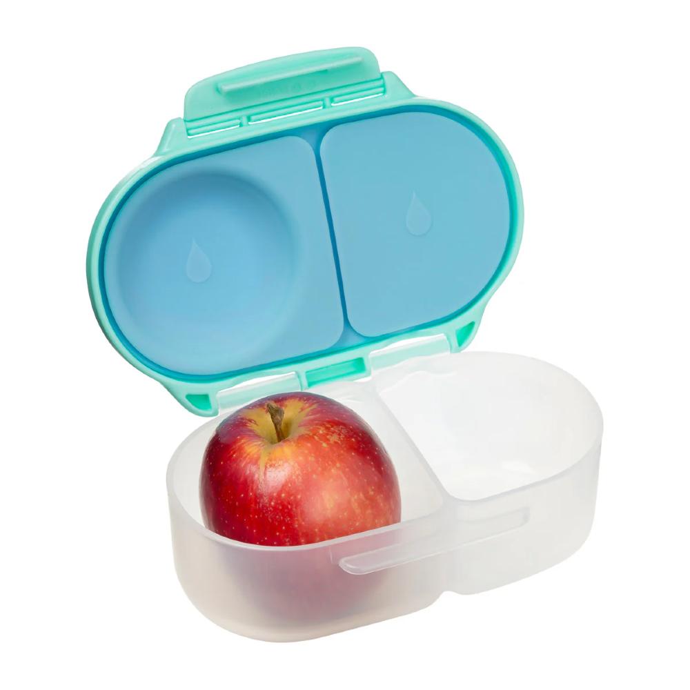 Open teal snack container with a red apple inside on a white background
