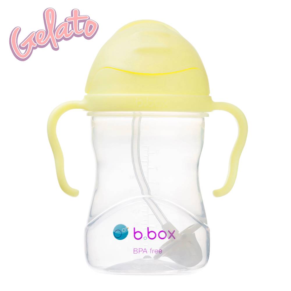 Clear baby sippy cup with yellow lid and handles on a white background, featuring the brand 'b.box'.