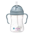 Clear sippy cup with blue lid and handles on a white background