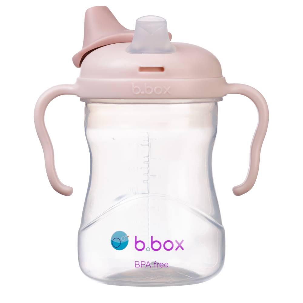 Pink sippy cup with clear body on a white background, featuring b.box logo.