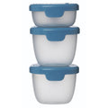 Set of three clear food storage containers with blue lids on a white background