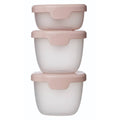 Three stacked containers with pink lids on a white background
