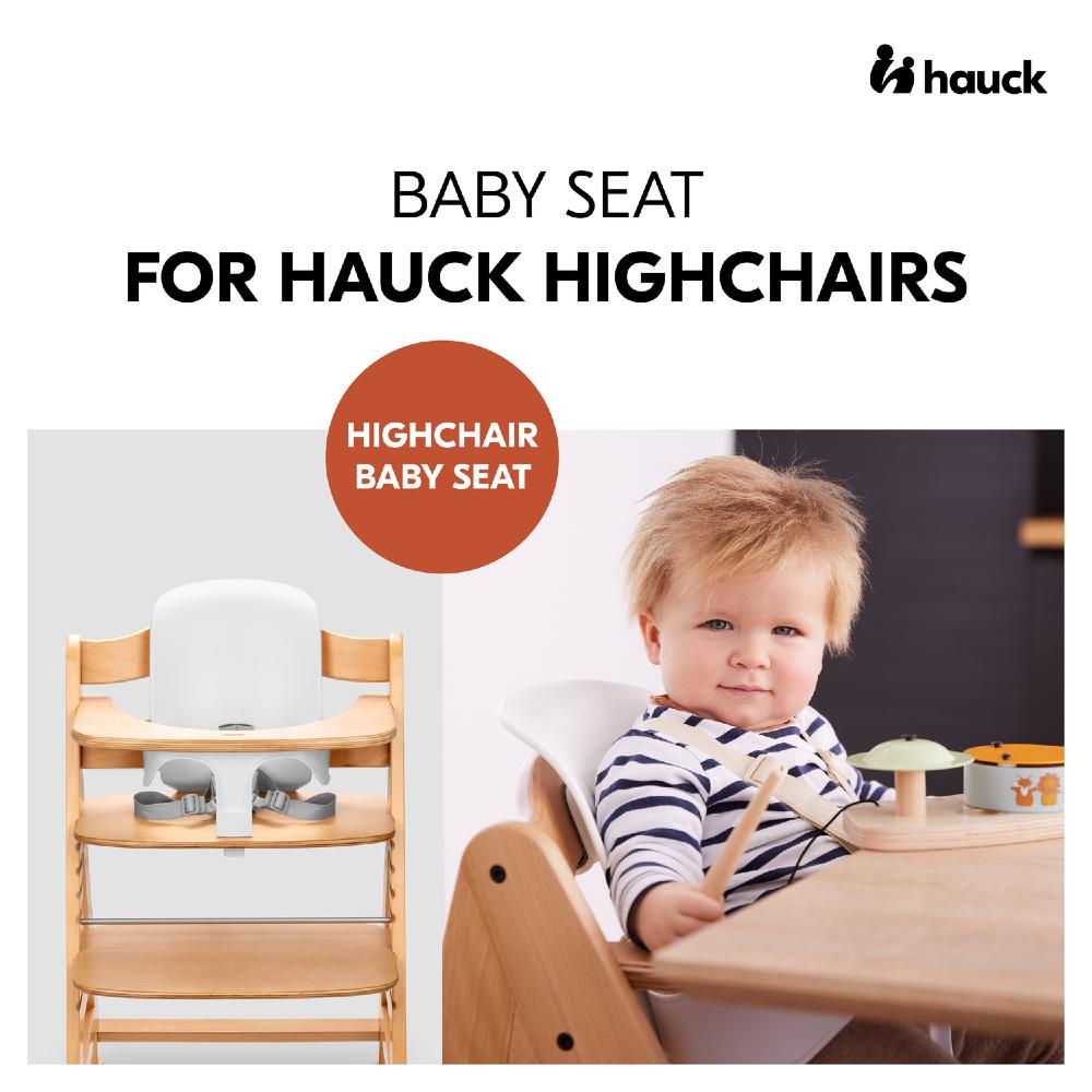 Hauck highchair with baby seat and a child using it, featuring the Hauck logo.