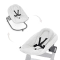 Light Grey Hauck baby bouncer with black straps on a white background
