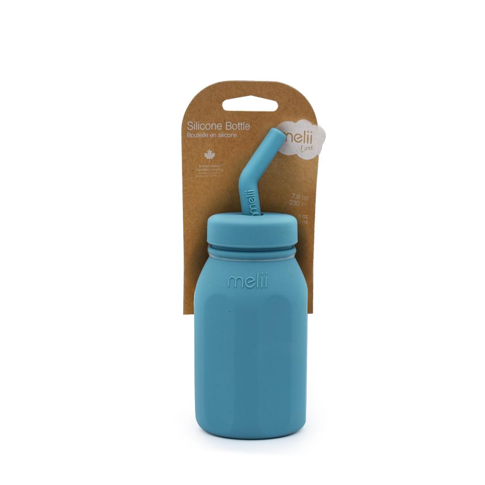 Blue Melii silicone bottle with straw lid and packaging on a white background